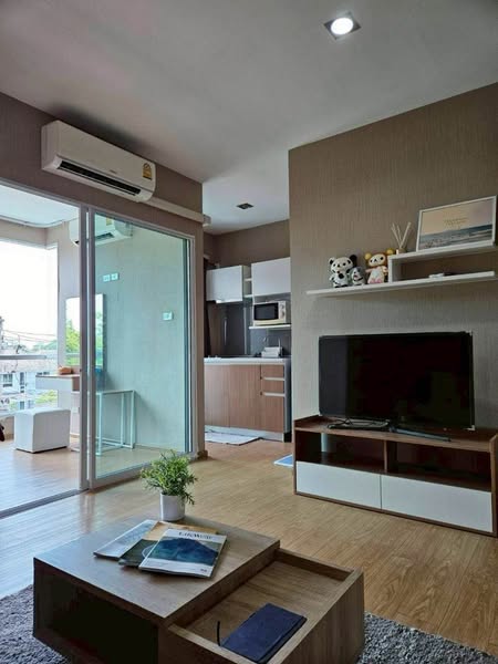 bedroom and living room of One Plus Nineteen 4 Condominium