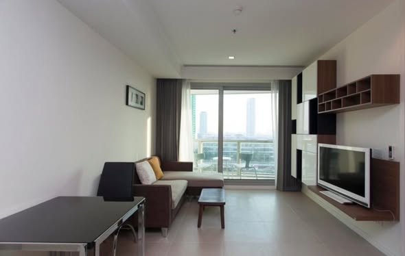 bedroom and living room of The River Condominium