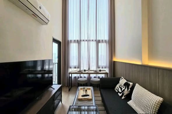 bedroom and living room of Altitude Unicorn Sathorn