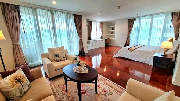 living room and bedroom of Piyathip Place Serviced Apartment