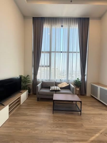 living room and bedroom of Ramada Plaza by Wyndham Bangkok Sukhumvit 48