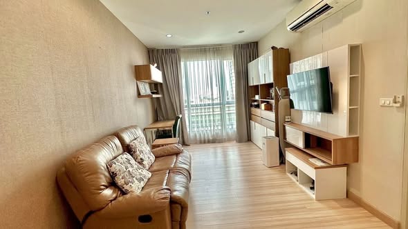 bedroom and living room of The Hotel Serviced Condo เดอะโฮเทล คอนโด