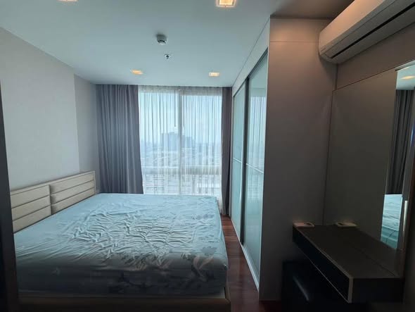 bedroom of The Metropolis Samrong
