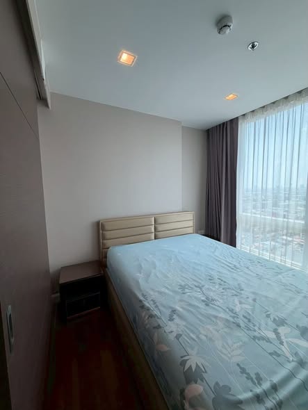 bedroom of The Metropolis Samrong
