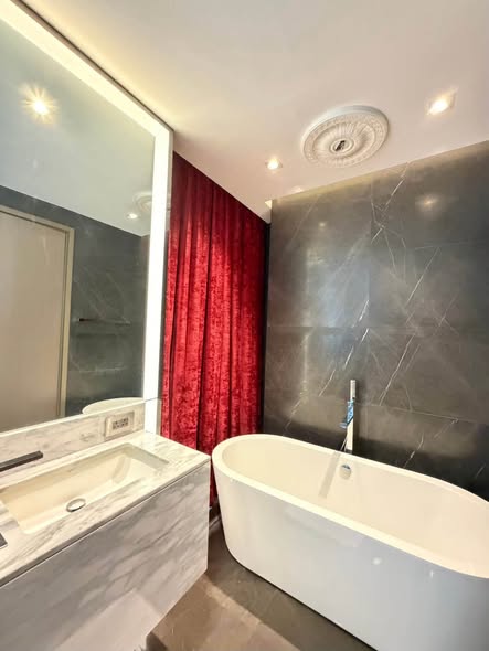bedroom and bathroom of The Monument Thong Lo
