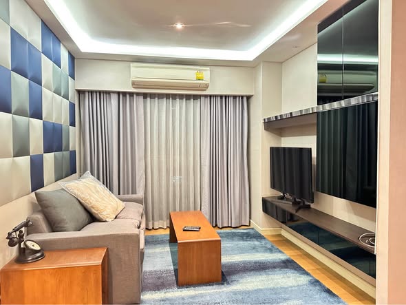 bedroom and living room of Tidy Deluxe Condominium