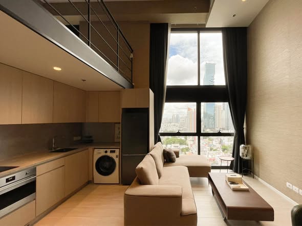living room and kitchen of The Lofts Silom by Raimon Land