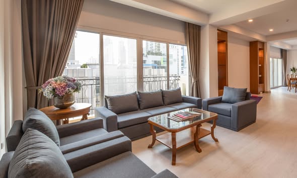 living room and bedroom of PARKROYAL Suites Bangkok