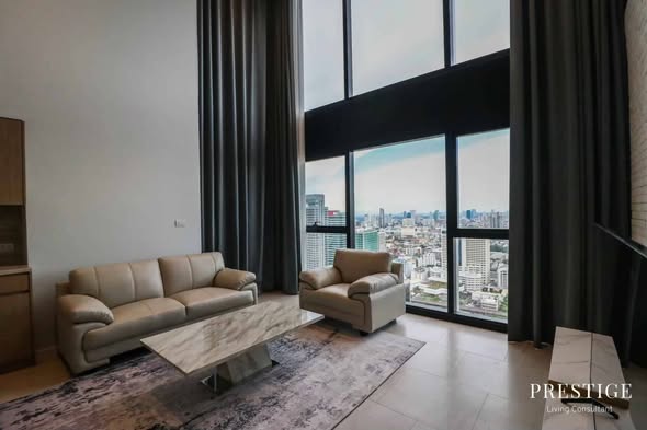 living room and bedroom of The Lofts Silom by Raimon Land