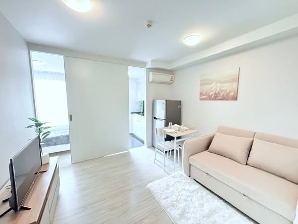 bedroom and living room of L Style Condo