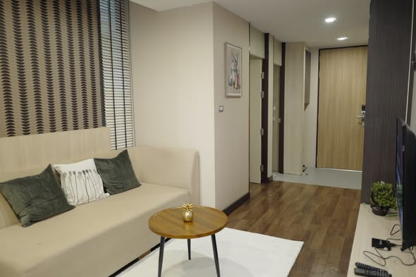 living room and bedroom of Qube Suites Sukhumvit 46