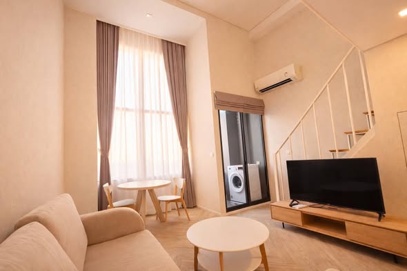 living room and bedroom of Ramada Plaza by Wyndham Bangkok Sukhumvit 48