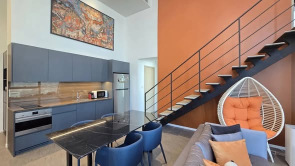 living room and kitchen of The Lofts Silom by Raimon Land
